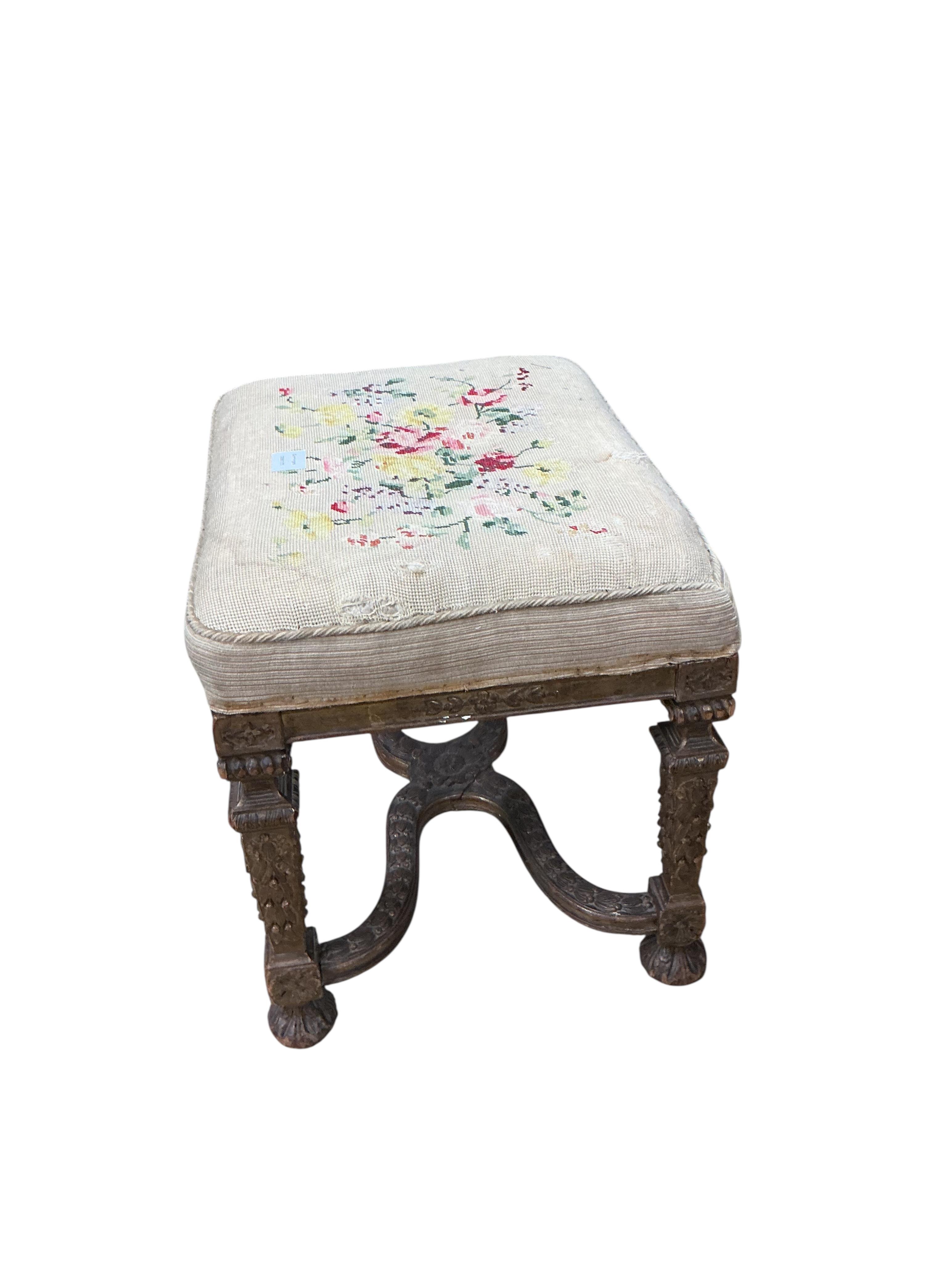 A 19th century carved giltwood dressing stool with shaped 'X' stretcher, width 56cm, depth 43cm, height 49cm